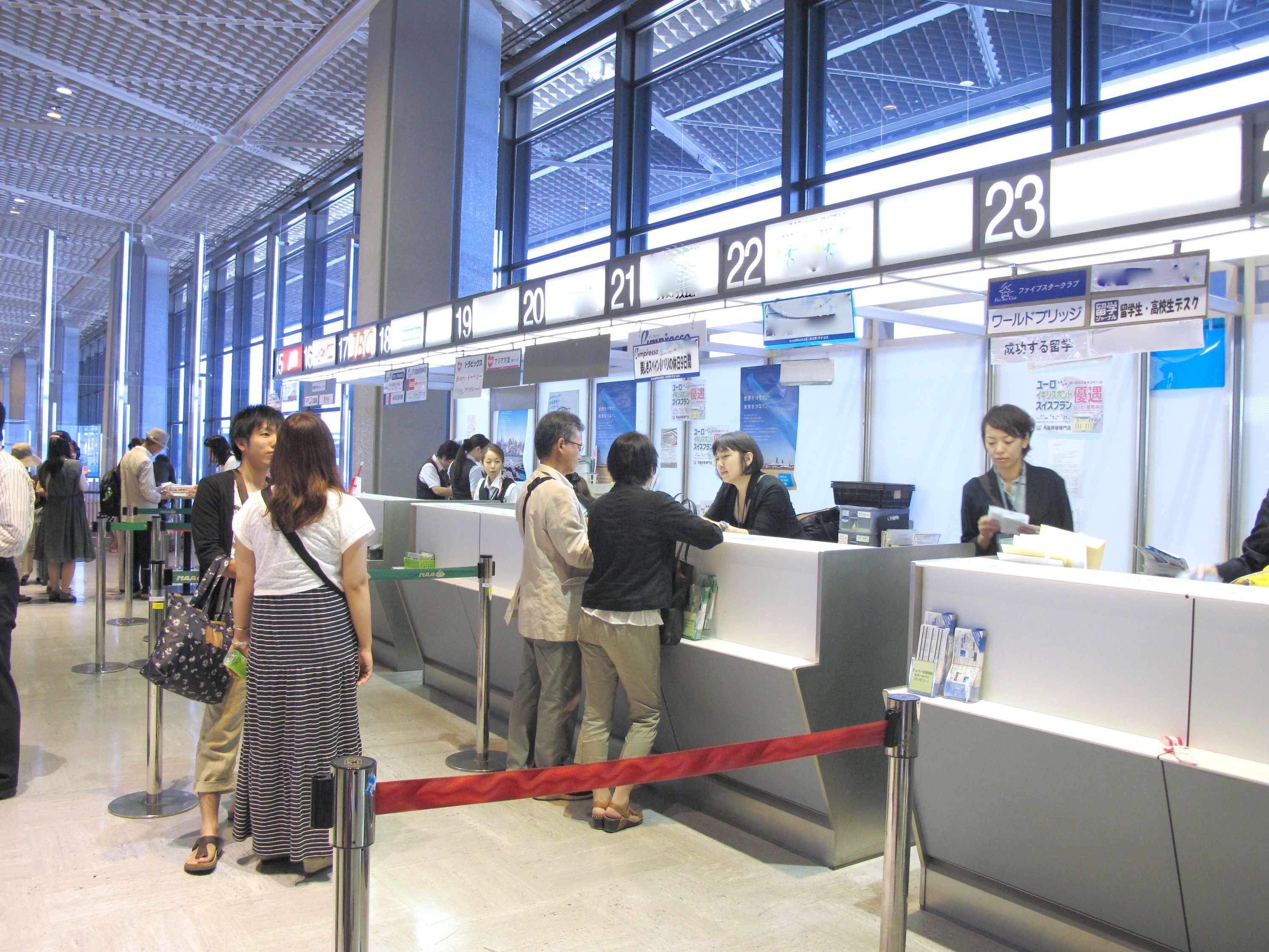 空港旅行会社カウンターでの業務風景